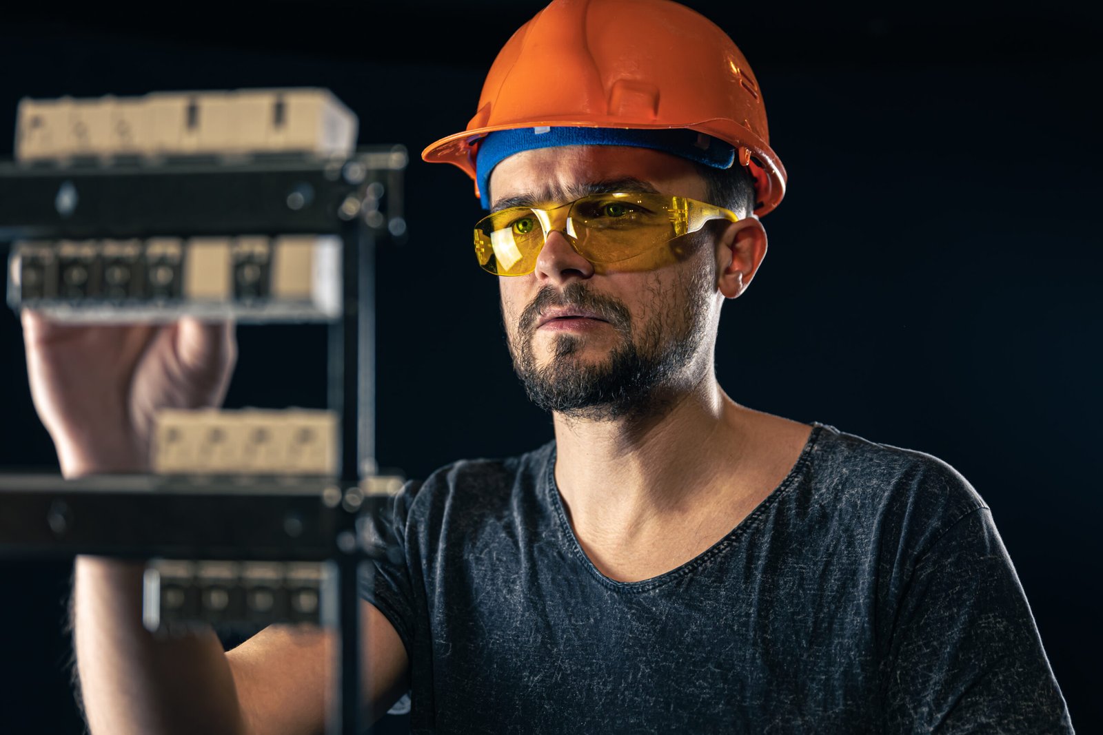 male electrician works switchboard with electrical connecting cable 2 scaled